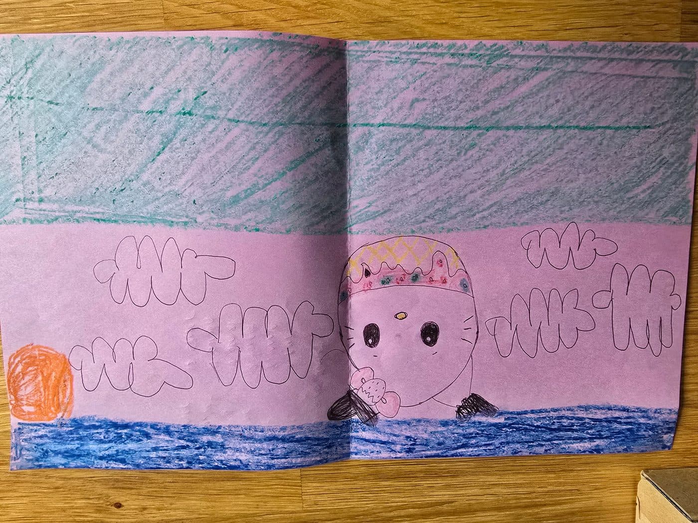 A strawberry kitty over a green sea